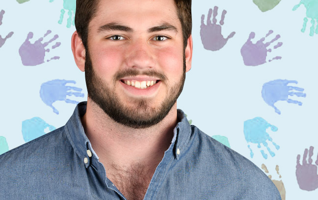 A student being superimposed in front of a background with hand paint prints.