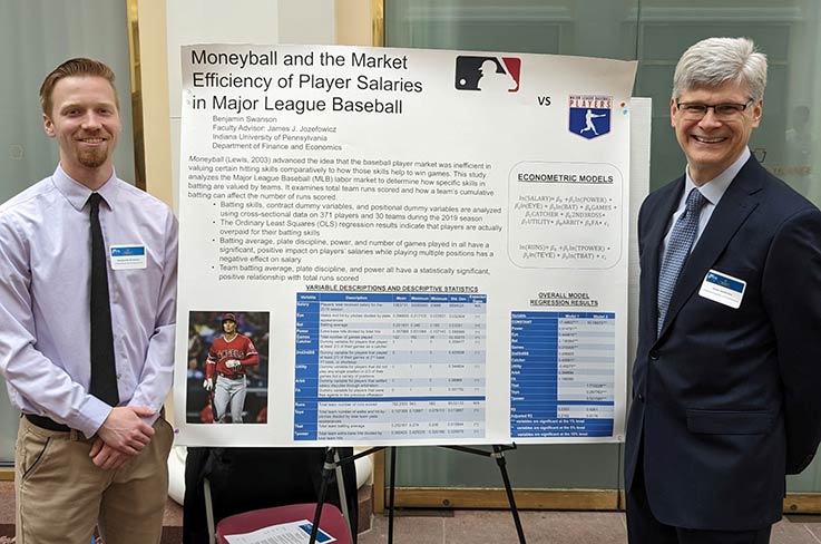 Student Ben Swanson and Professor Jim Jozefowicz with their poster at the 2023 Undergraduate Research at the Capitol event