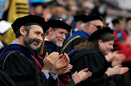 Alumni clapping during commencement 