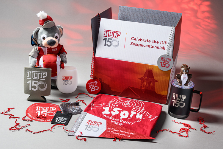 the 150 celebration box and its contents, including stuffed bear, travel coffee mug, wine mug, tshirt, stickers.