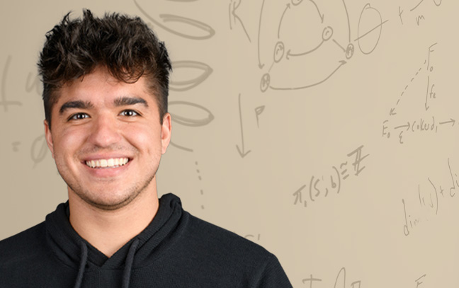 young male student smiling with a background of math equations