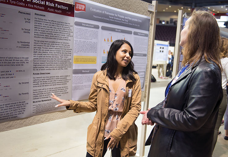 Student presenting her research at the Scholars Forum 