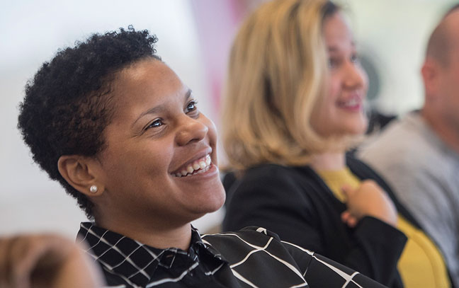 close up of a smiling person in a classroom