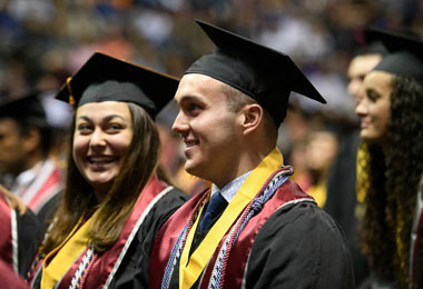 close up side profile of students standing in line at graduation