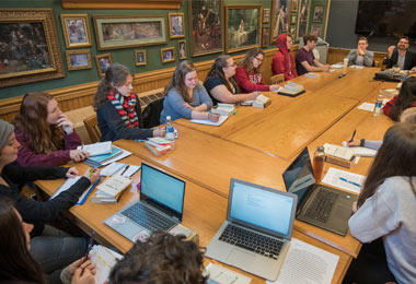 a small class of students in the honors college sitting around a table