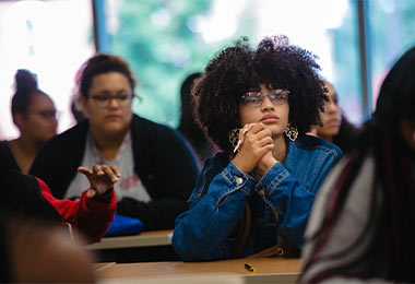 front view of students sitting at desks listening to a lecture