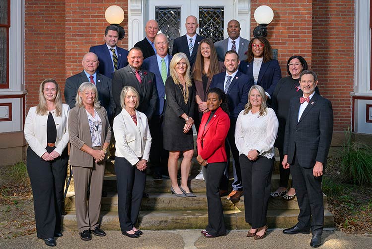 IUP Alumni Association Board of Directors posing on the steps of Breezedale