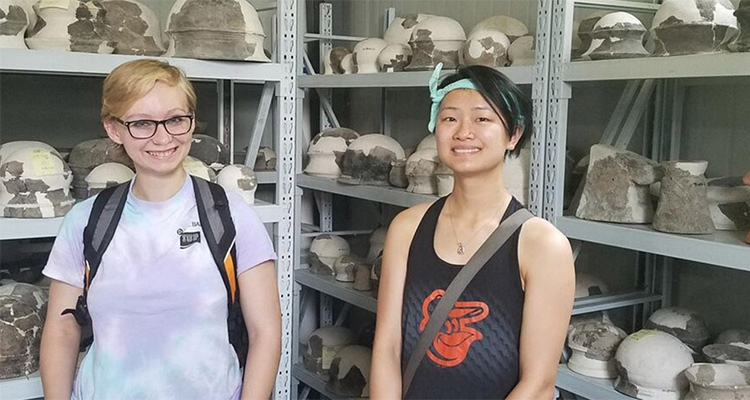 Students examining pottery an overseas trip to China