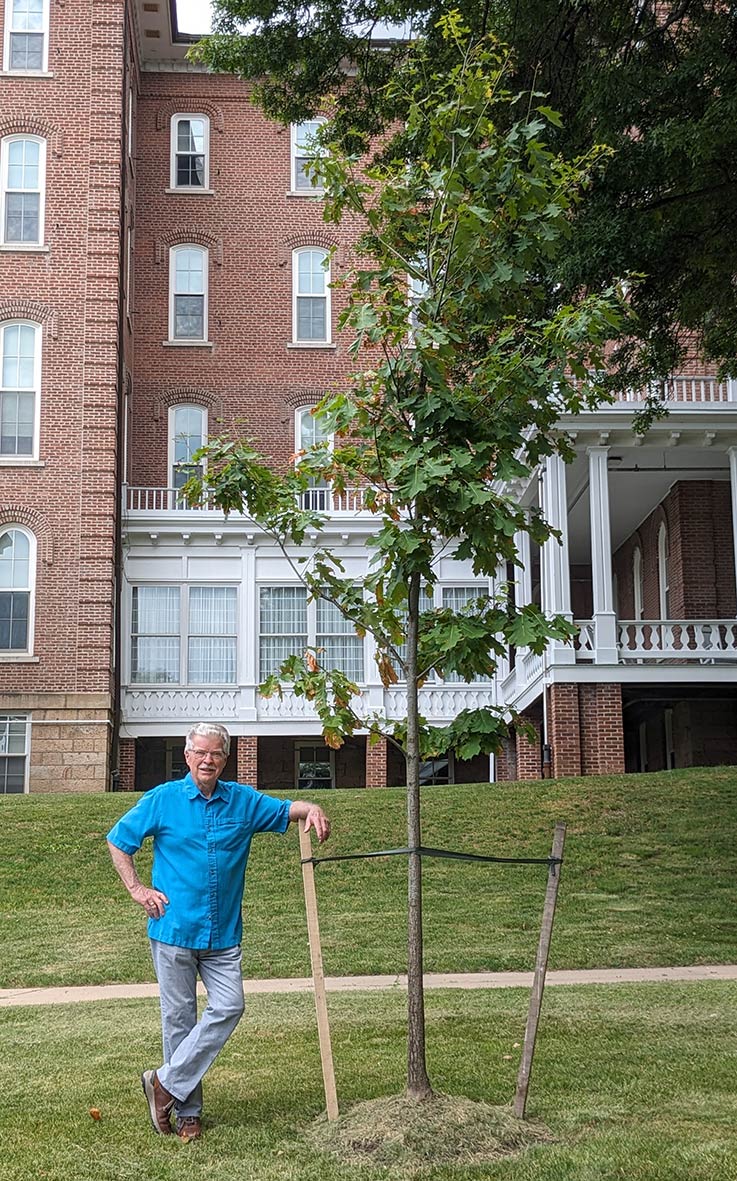 Jerry Pickering with a red oak donated in his honor on the East Lawn