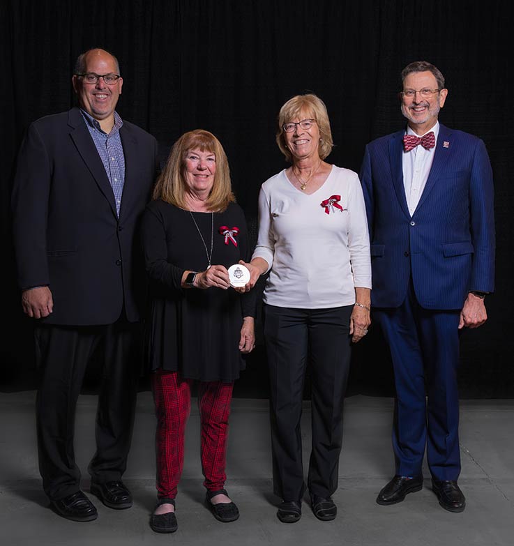 IUP Athletics Director Todd Garzarelli, Barb Beatty Patterson ’78, Lynn Roser Wagner ’76, and IUP President Michael Driscoll