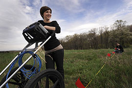 A student runs ground-penetrating radar equipment as part of an archaeological survey. A student runs ground-penetrating radar equipment as part of an archaeological survey.