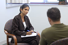 Psychology graduate student talking with student Psychology graduate student talking with student