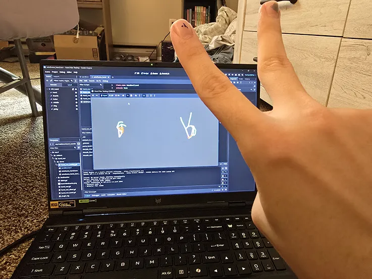 closeup of a hand being tracked on a laptop camera