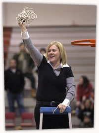 Cindy Martin cuts down the net after leading her team to the PSAC Championship