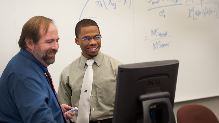 Sultan Magruder and Professor Jay Mills discussing a psychology research project