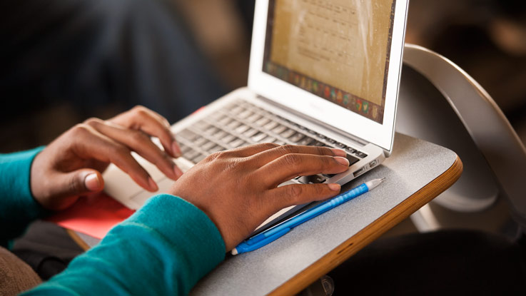 Student working on a laptop in a classroom