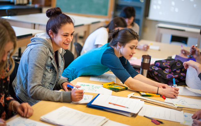 Students sitting as a teacher lectures