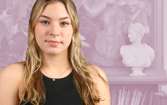 female student with colorized sculpture in the background