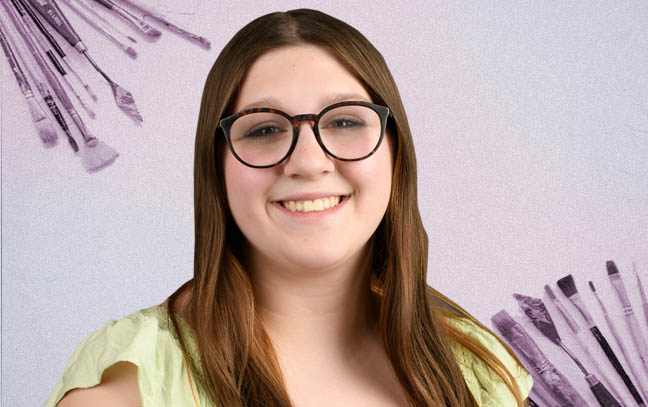 female student with a background of paintbrushes