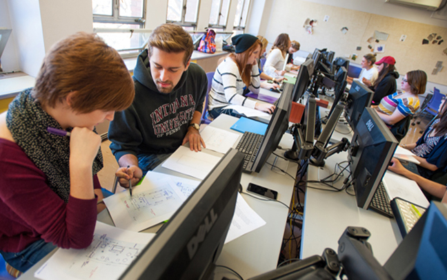 Student working with a teacher on a project