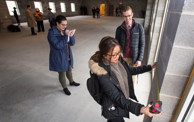 interior design students measure an interior space