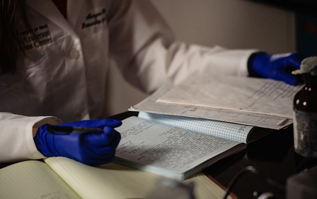 close up of a student wearing gloves in a lab