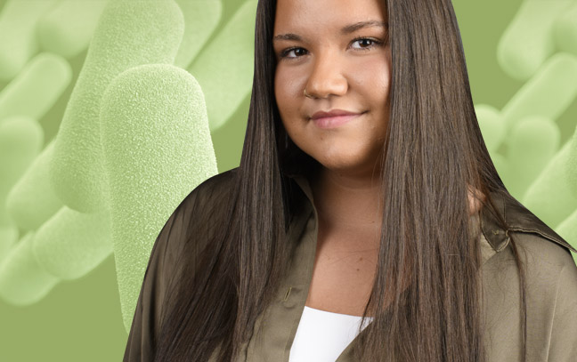 A student being superimposed in front of a lime-green background with bacteria.
