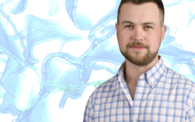 A student being superimposed in front of a blue and white background.