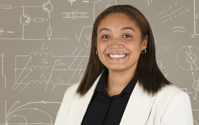 a female student in front of a gray board background image