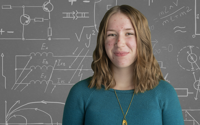 Femal with dark green jumper, and grayboard background image 