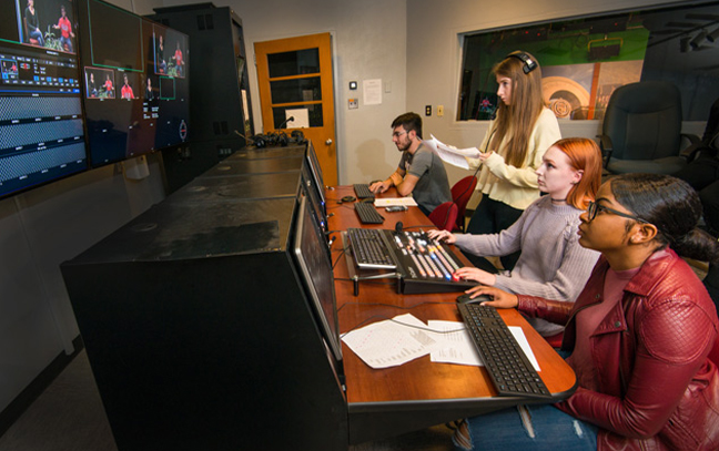 students working the controls in a studio