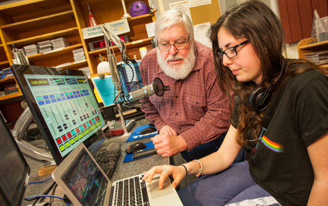 professor showing a student something on a computer in a lab