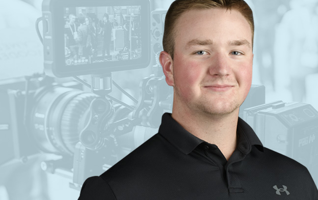 A student being superimposed in front of a blue background with photographic equipment.