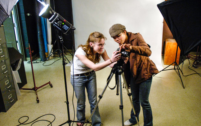 Students talking while working in a photography studio