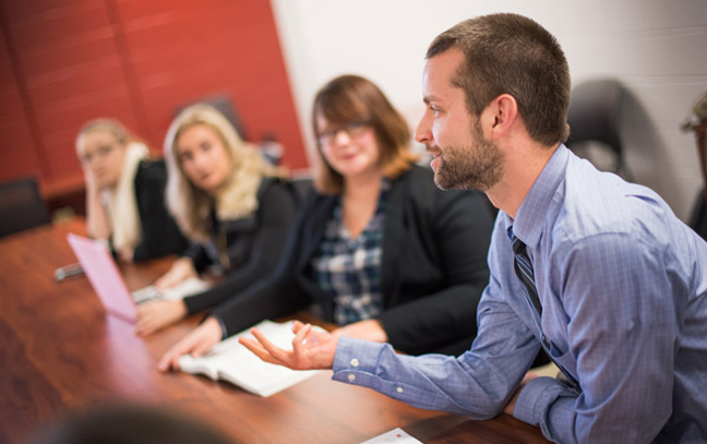 students sitting in a classroom talking