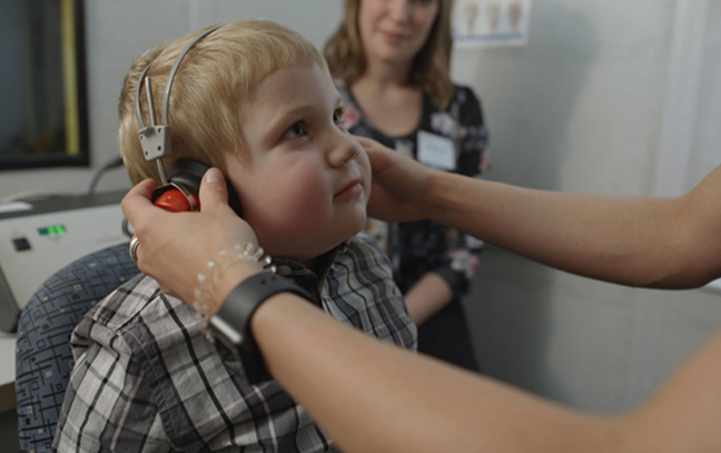 speech language pathology student working with a boy