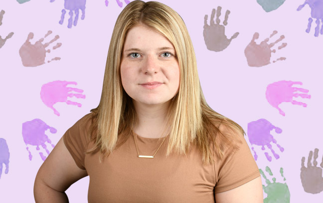 A student being superimposed in front of a pink background with hand paint prints.