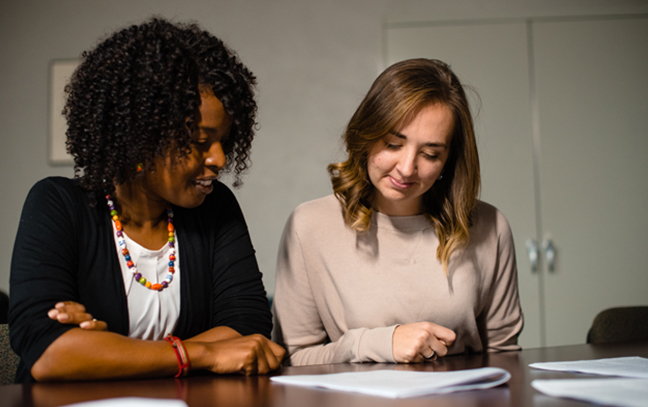 student and teacher looking at documents