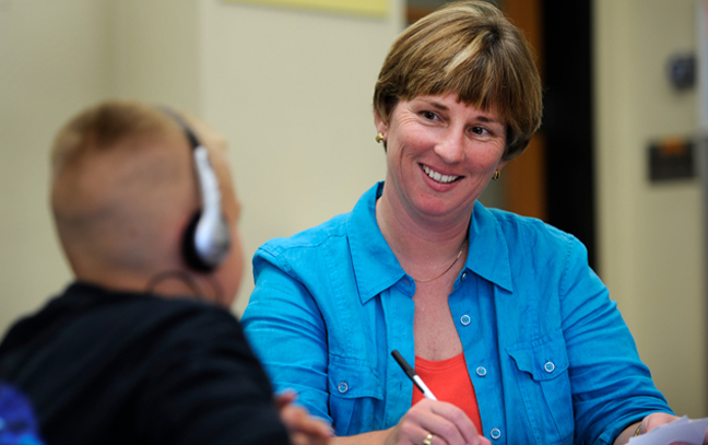 woman working with a boy in a speech lab