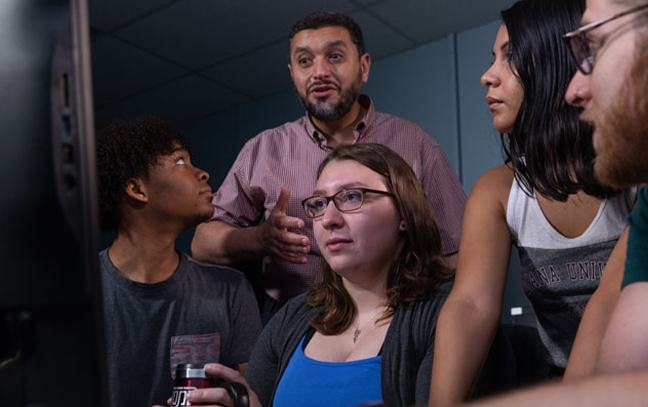 group of students looking at a screen