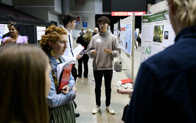 a student presents their research at a research event