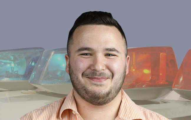 A student being superimposed in front of a background showing the roof of a police car.