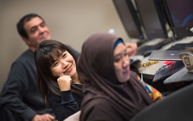 three students look off camera during a class