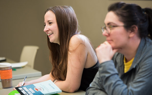 two students look off camera during a class
