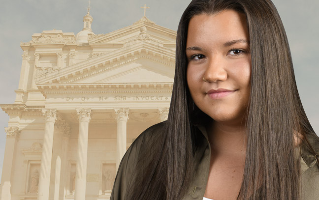 A student being superimposed in front of a sand yellow background with a structure.