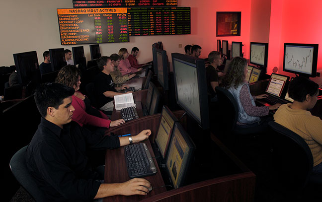 Eberly students working on computers in the trade floor room