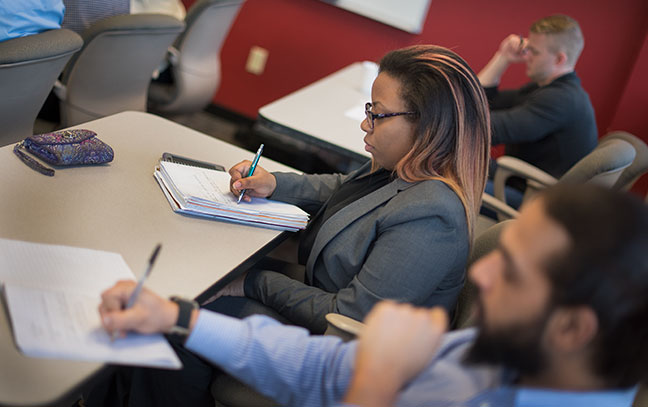 close up of students writing during class