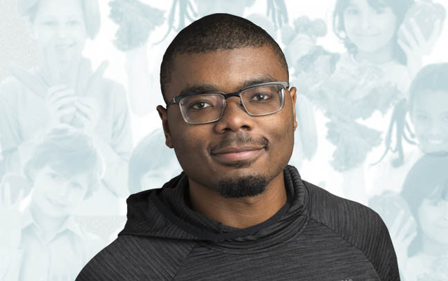 a male student superimposed on a blue backdrop containing a children holding fruits and vegetables