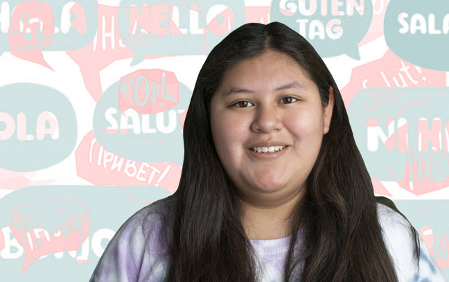 A female student in front of a detailed backdrop with pink and blue chat bubbles.