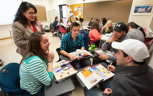 group of students talking together in a spanish classroom